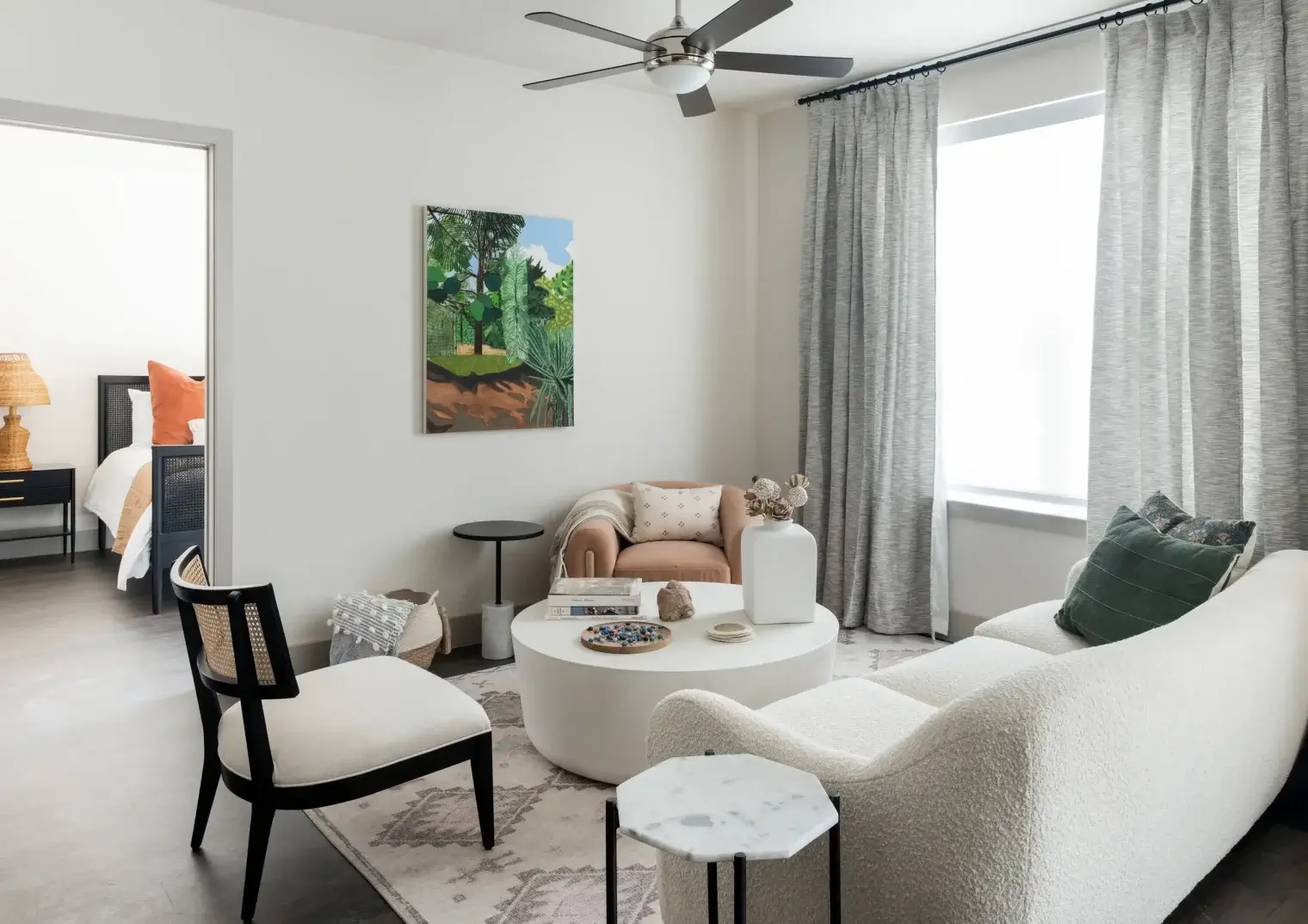 Bright Six Pines apartment living room with modern furnishings and large windows in Shenandoah TX