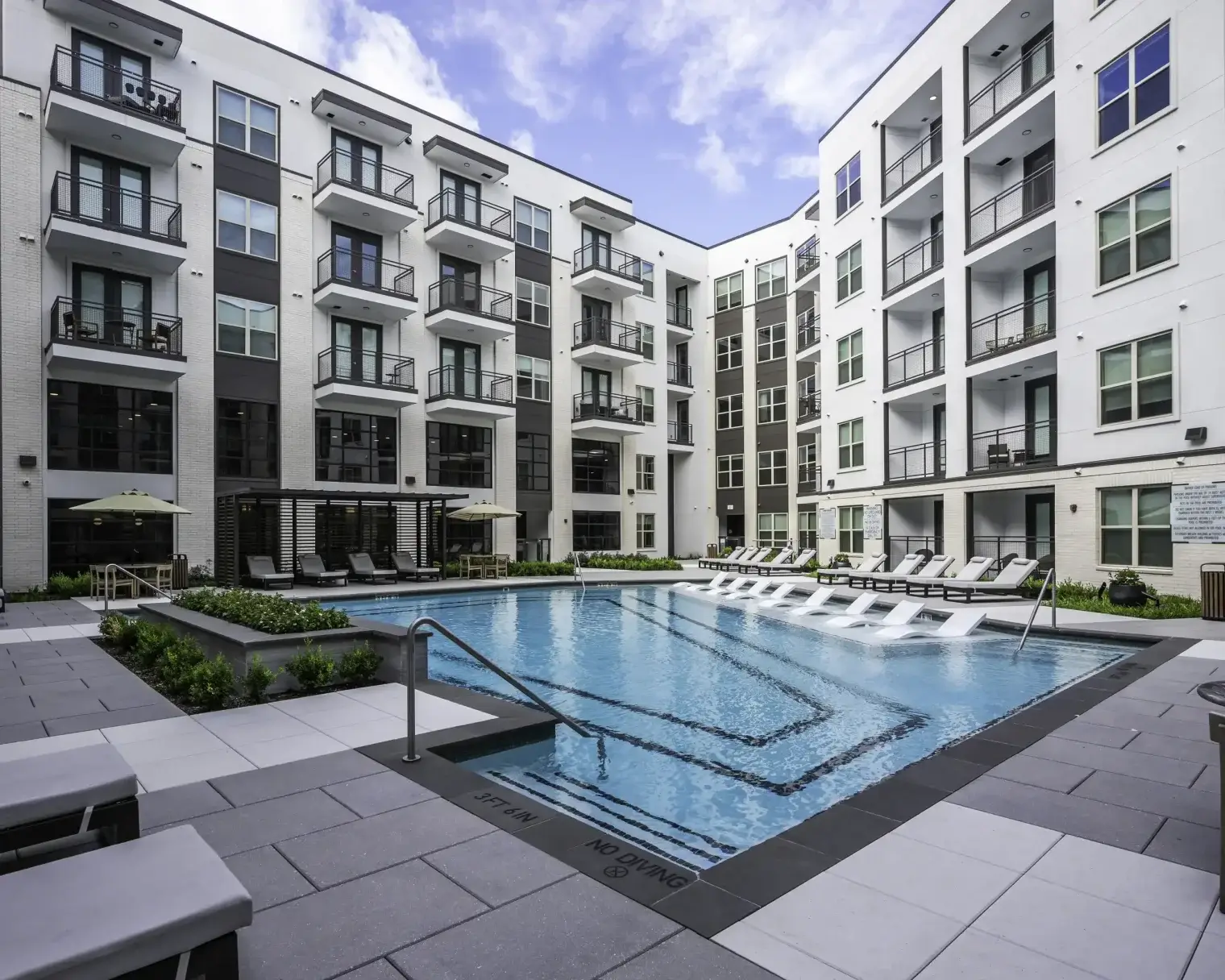 Hotel-inspired swimming pool and lounge area at Six Pines apartments near The Woodlands