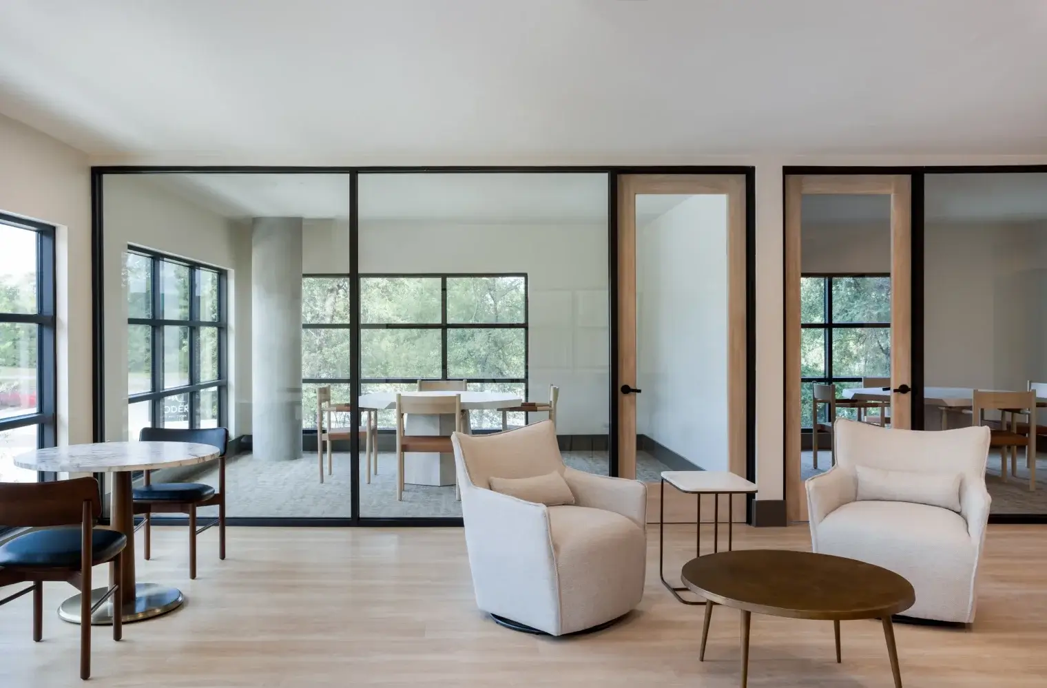 Modern resident lounge with seating and workspaces at Six Pines apartments in Shenandoah TX